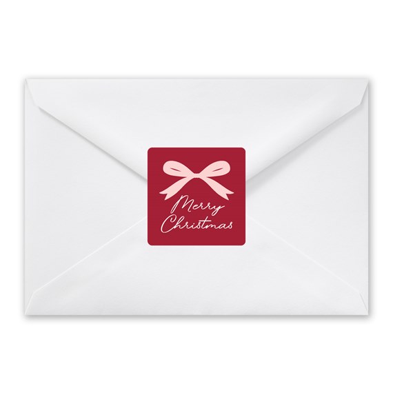 envelope with a red seal and bow design