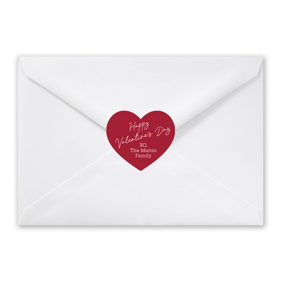 white envelope with red heart seal and text
