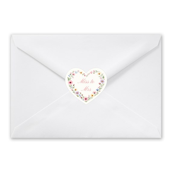 white envelope with heart-shaped floral seal and text
