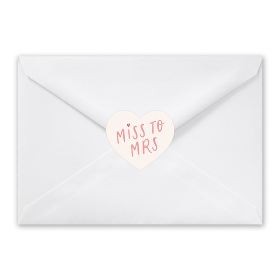 white envelope with heart seal and text
