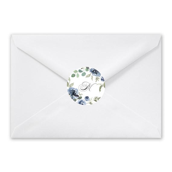 white envelope with floral seal and letter M