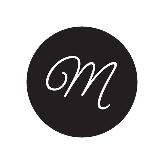 black envelope seal with white cursive M