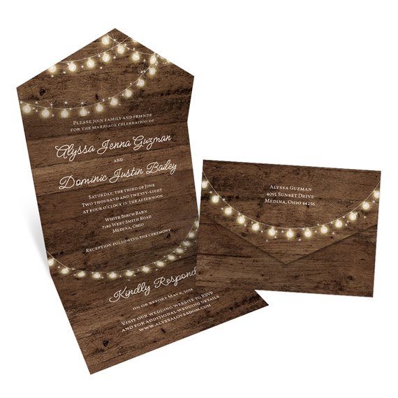 wooden wedding invitation with string lights and matching envelope