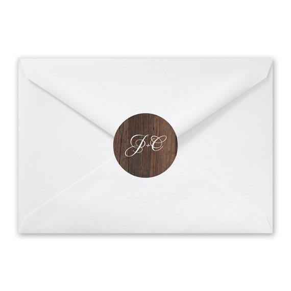 white envelope with wood texture seal and initials